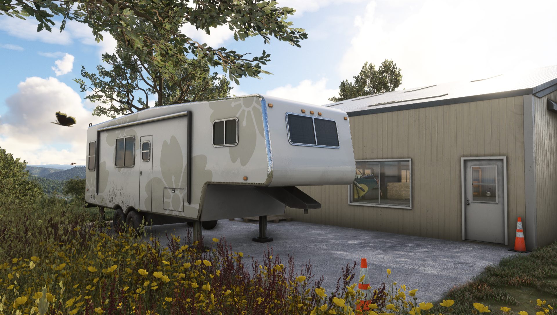 A white camper is parked beside a beige hangar surrounded by wildflowers. A butterfly flies near a tree, set against a blue sky with clouds.